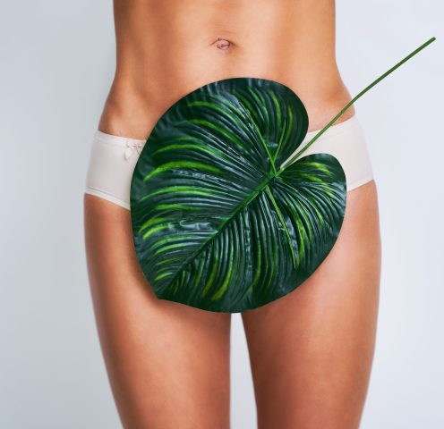 Picture of beautiful adult woman posing against leaf background